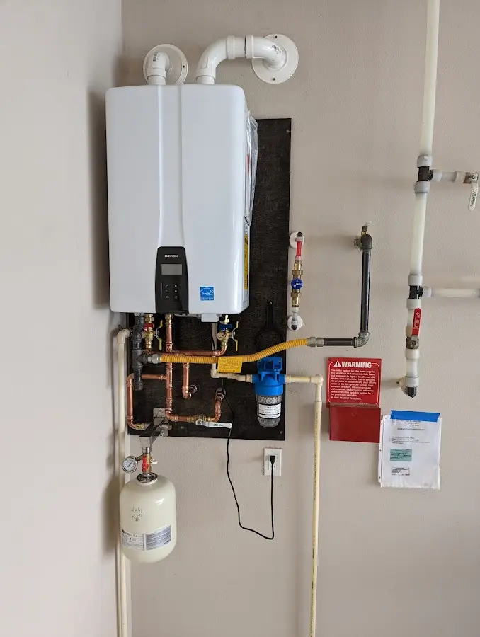 Professional plumber installing copper piping in a Linton home